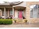 Inviting front porch with stone accents and comfortable seating area at 1976 Hedge Brooke Nw Trl, Acworth, GA 30101