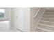 Bright hallway with carpeted stairs and view to the living area at 1976 Hedge Brooke Nw Trl, Acworth, GA 30101
