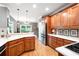 Well-lit kitchen with wood cabinets, stainless steel refrigerator, and light countertops at 1976 Hedge Brooke Nw Trl, Acworth, GA 30101
