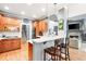 Contemporary kitchen with wooden cabinets, and breakfast bar overlooking the living room at 1976 Hedge Brooke Nw Trl, Acworth, GA 30101