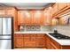 Well-appointed kitchen with wooden cabinets, white countertops, and stainless steel appliances at 1976 Hedge Brooke Nw Trl, Acworth, GA 30101