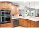 Gourmet kitchen with stainless steel appliances, wooden cabinets, and built-in double oven at 1976 Hedge Brooke Nw Trl, Acworth, GA 30101