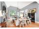 Bright living room with fireplace, hardwood floors, and large windows overlooking outdoor deck and landscaped yard at 1976 Hedge Brooke Nw Trl, Acworth, GA 30101