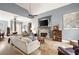 Inviting living room showcasing a stone fireplace, hardwood floors, and abundant natural light at 1976 Hedge Brooke Nw Trl, Acworth, GA 30101