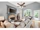 Relaxing living room featuring a fireplace, large window and comfortable sofa with plush pillows at 1976 Hedge Brooke Nw Trl, Acworth, GA 30101