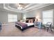 Bedroom with tray ceilings, carpet, ceiling fan, and two bedside tables at 1976 Hedge Brooke Nw Trl, Acworth, GA 30101
