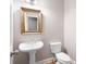 Classic powder room with pedestal sink, framed mirror, and tile flooring at 1976 Hedge Brooke Nw Trl, Acworth, GA 30101