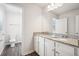 Bathroom vanity with double sinks, granite countertop and wood-look floors at 3001 Viewpark Cir, Conyers, GA 30013