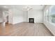 Bright living room featuring a modern fireplace, light wood floors, and plenty of natural light at 3001 Viewpark Cir, Conyers, GA 30013