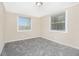 Neutral bedroom with two windows letting in ample natural light and plush gray carpeting at 3409 Glensford Dr, Decatur, GA 30032