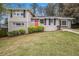 Charming brick home featuring a split-level design and inviting red front door at 3409 Glensford Dr, Decatur, GA 30032