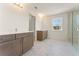 Bathroom featuring double sink vanity, modern lighting, white walls, and marble floors at 162 Spaulding Ln, Woodstock, GA 30188