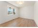 Bright, empty room with hardwood floors, a modern ceiling light, and a large window at 162 Spaulding Ln, Woodstock, GA 30188