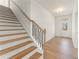 Bright foyer featuring stairs with wooden treads, iron railings, and hardwood floors at 162 Spaulding Ln, Woodstock, GA 30188