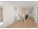 Upstairs hallway featuring hardwood floors, a modern railing, and doorways to other rooms at 162 Spaulding Ln, Woodstock, GA 30188