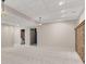 Basement space with neutral paint, wall to wall carpeting, and two pendant lights at 3031 Clove Tree Ln, Woodstock, GA 30189