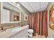 Bathroom featuring a granite countertop vanity, framed mirror, and shower/tub with a striped curtain at 3031 Clove Tree Ln, Woodstock, GA 30189