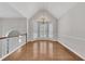 Bright dining room features hardwood floors, vaulted ceiling, and a stylish chandelier at 3031 Clove Tree Ln, Woodstock, GA 30189