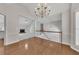 Dining room adjacent to living room showcases hardwood floors and an elegant chandelier at 3031 Clove Tree Ln, Woodstock, GA 30189