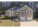 Charming two-story home with gray siding, well-manicured landscaping, and a two-car garage at 3031 Clove Tree Ln, Woodstock, GA 30189