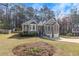 Well-maintained home with gray siding, a two-car garage, and landscaping, set in a wooded area at 3031 Clove Tree Ln, Woodstock, GA 30189