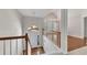 Bright foyer with hardwood floors, white railings, and an arched window above the front door at 3031 Clove Tree Ln, Woodstock, GA 30189