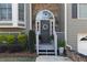 Close-up of the front door, featuring a wreath, stone accents, and manicured bushes at 3031 Clove Tree Ln, Woodstock, GA 30189