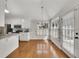 Eat-in kitchen area with hardwood floors, lots of natural light and white cabinets at 3031 Clove Tree Ln, Woodstock, GA 30189