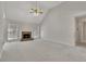 Bright living room with vaulted ceilings, a stone fireplace, and neutral carpet at 3031 Clove Tree Ln, Woodstock, GA 30189