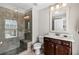 Updated bathroom featuring tiled shower with a bench and a dark wood vanity at 3845 Williams Point Dr, Cumming, GA 30028