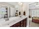 Bathroom with double sinks and mirrors and doorway to bedroom at 3845 Williams Point Dr, Cumming, GA 30028