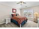 Bright bedroom featuring carpet, ceiling fan, and a large window to let in natural light at 3845 Williams Point Dr, Cumming, GA 30028