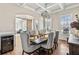 Formal dining room with modern chandelier, wood floors and adjacent butler's pantry at 3845 Williams Point Dr, Cumming, GA 30028