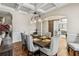 Open dining room with coffered ceiling, chandelier, and view into an office at 3845 Williams Point Dr, Cumming, GA 30028