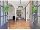 Welcoming foyer with hardwood floors, elegant lighting, and arched doorways at 3845 Williams Point Dr, Cumming, GA 30028