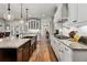 Open kitchen featuring granite island with a stainless sink and counter seating at 3845 Williams Point Dr, Cumming, GA 30028