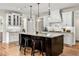 Spacious kitchen features white cabinets, a center island and modern pendant lighting at 3845 Williams Point Dr, Cumming, GA 30028