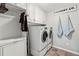 Well-organized laundry room with white cabinets and modern washer and dryer at 3845 Williams Point Dr, Cumming, GA 30028