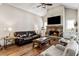 Well-lit living room featuring hardwood floors, stone fireplace, and comfortable seating arrangement at 3845 Williams Point Dr, Cumming, GA 30028