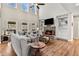 Cozy living room with a high ceiling, fireplace, built-ins, and large windows at 3845 Williams Point Dr, Cumming, GA 30028