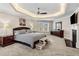 A spacious main bedroom boasts a tray ceiling, fireplace, and large windows at 3845 Williams Point Dr, Cumming, GA 30028