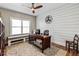 Bright home office with hardwood floors, shiplap accent wall, and large window at 3845 Williams Point Dr, Cumming, GA 30028