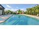 Community pool surrounded by lounge chairs, landscaping, and a black metal safety fence at 3845 Williams Point Dr, Cumming, GA 30028