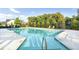 Community pool surrounded by lounge chairs, landscaping, and a black metal safety fence at 3845 Williams Point Dr, Cumming, GA 30028