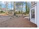 Backyard with brick patio, perfect for outdoor relaxation and entertaining, surrounded by mature trees at 4506 Reva Ne Way, Marietta, GA 30066