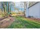 Landscaped backyard with mature trees, a playground, and a well-maintained lawn at 4506 Reva Ne Way, Marietta, GA 30066