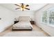 Cozy bedroom featuring hardwood floors, ceiling fan, and side tables with lamps at 4506 Reva Ne Way, Marietta, GA 30066