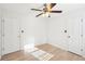 Bedroom featuring wood floors, natural light, a ceiling fan, and two doors at 4506 Reva Ne Way, Marietta, GA 30066