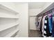 Walk-in closet featuring built in shelves and hanging rods for clothing storage at 4506 Reva Ne Way, Marietta, GA 30066