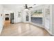 Bright dining area featuring hardwood floors, a ceiling fan, and large windows with wooded views at 4506 Reva Ne Way, Marietta, GA 30066